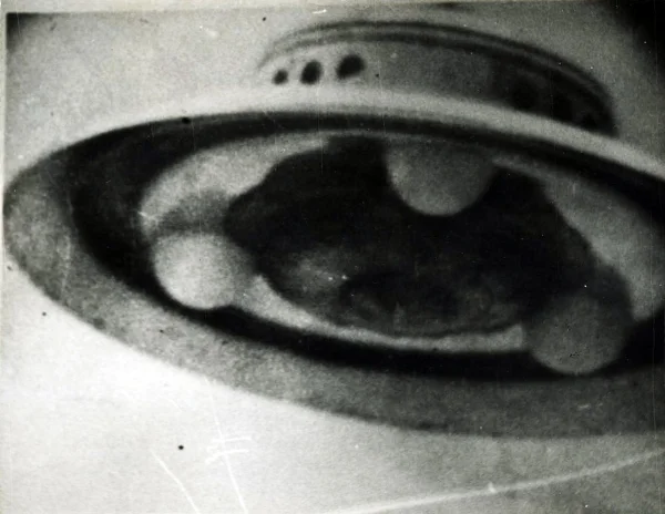 Photograph of an unidentified flying object taken in 1952 by George Adamski, a prolific American photographer of UFOs. Adamski claimed to have several encounters with aliens beginning in the late '40s, and even stated that he had been taken aboard alien spacecrafts and traveled to different planets. His claims drew the attention of several skeptics, and after a series of investigations, his photographs were eventually discredited. Courtesy of the artist's archive.