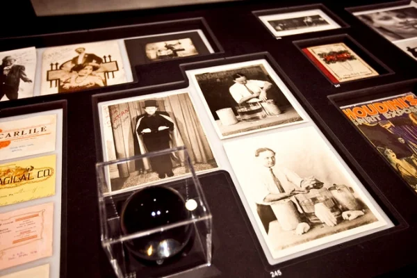 A scrying ball used by magicians and archival photographs featuring the magician Wilfred Sellten, left, and Harry Houdini. CreditByron Smith for The New York Times