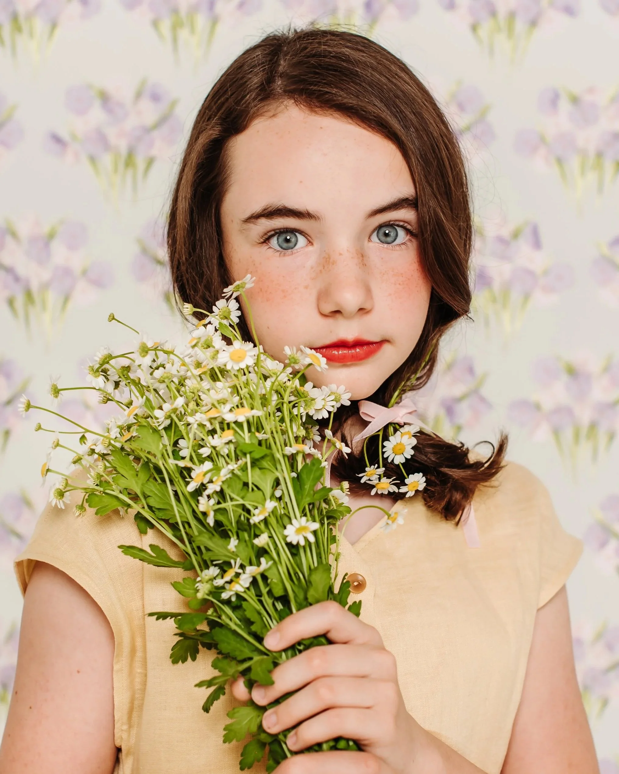 a girl holding a flower for creative portrait session in california