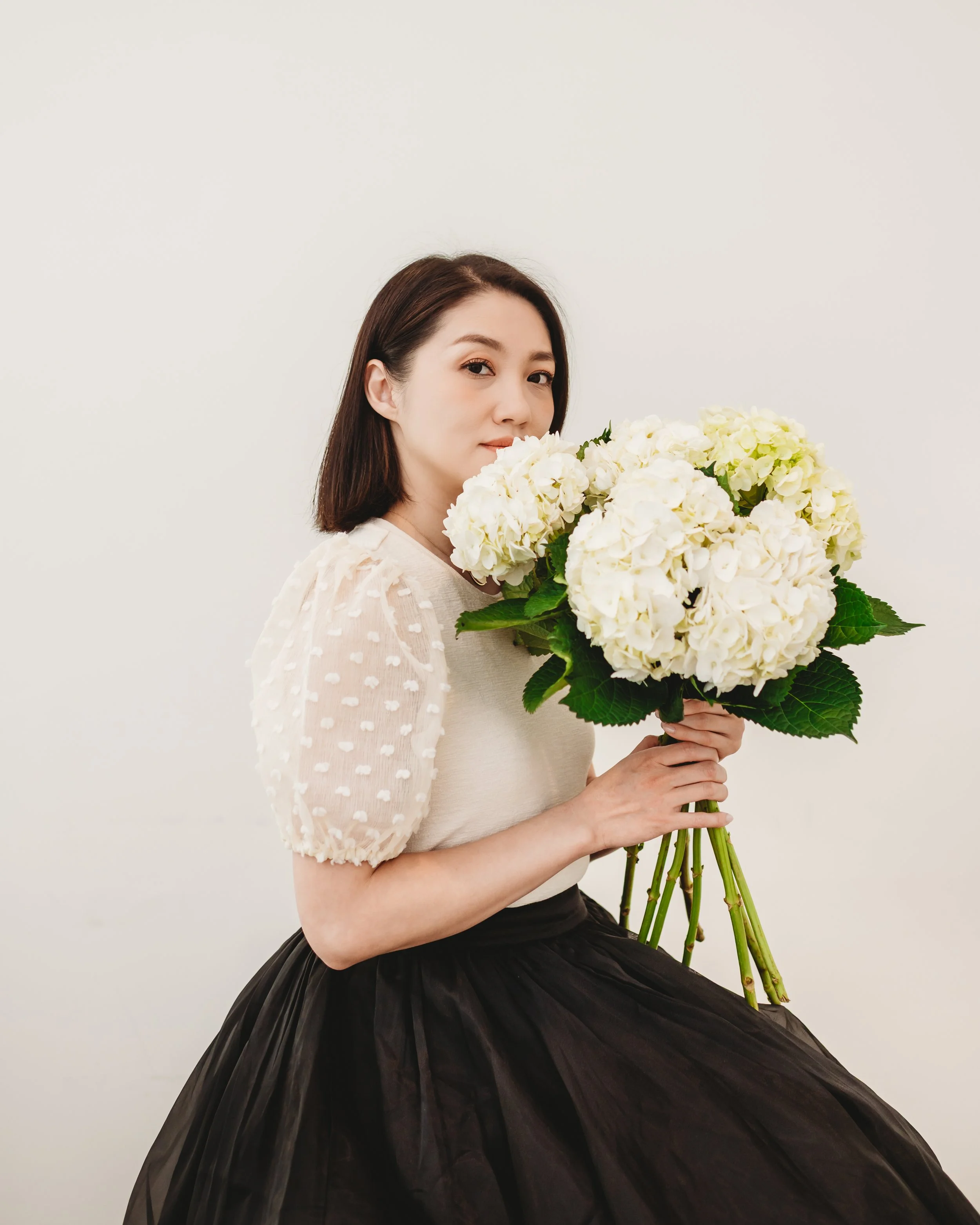 a lady holding flowers for creative portrait photo session in glendale