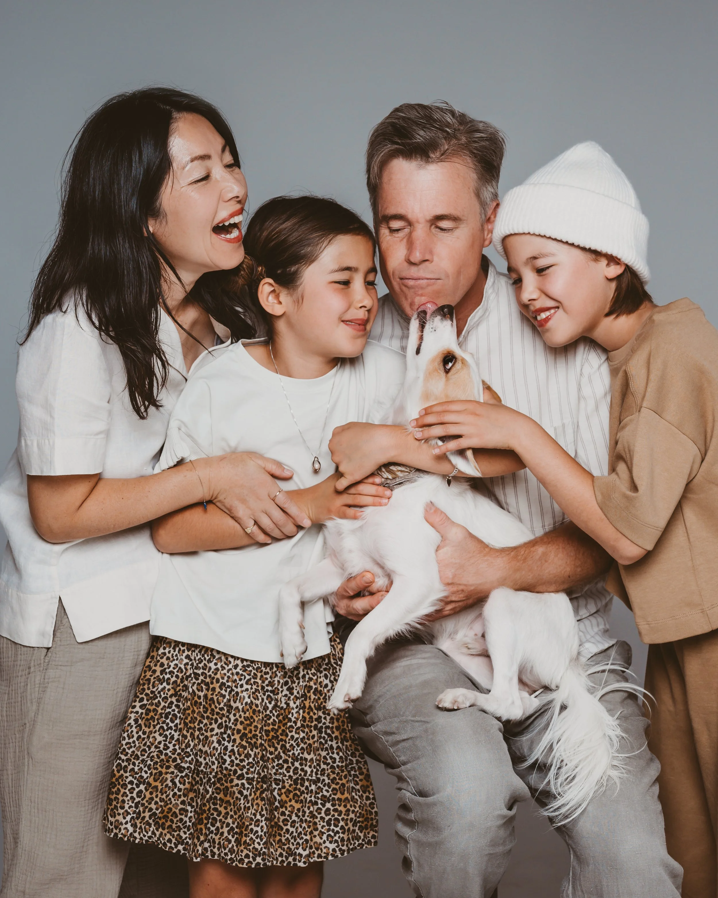 family portrait session with a pet licking dad's face