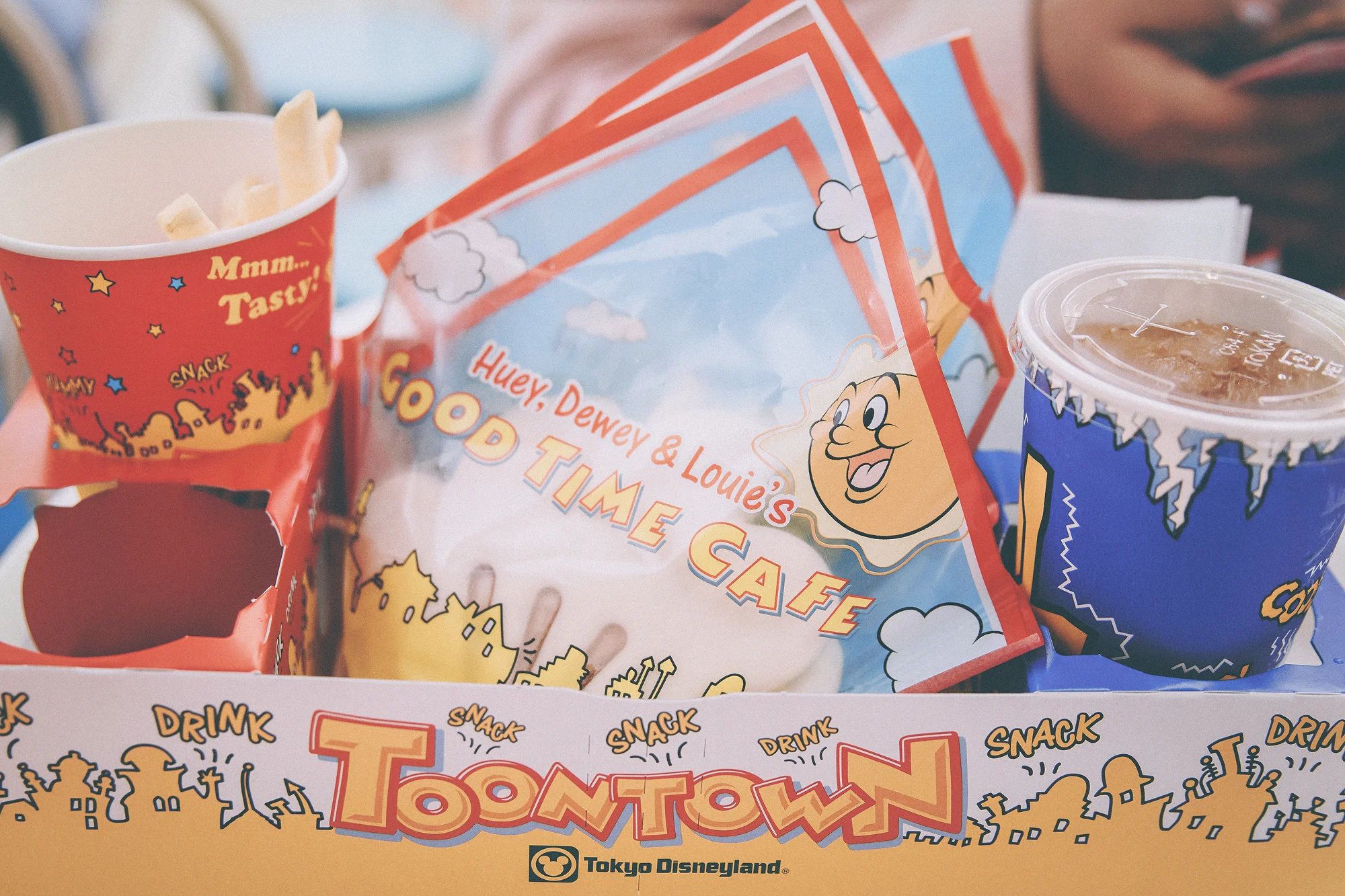 Let’s get down to it, I am someone who is very particular about graphic design, and there’s nothing better than something that is visually pleasing and actually useful! Tokyo Disneyland has some of the most unique food packaging that I’ve seen in the Disney Parks that puts the fun in functional. For instance, there are little pizza boxes perfectly designed to fit just a single slice (fun fact: these boxes have been around TDL since the 80s!) In addition, most quick service locations serve your meal in a box sets specially designed with cup holders so your drink and fries always have a spot. Even their wrappers for sandwiches and buns are collectible. These little details, especially area specific goods, are all apart of the Tokyo Disney experience. They set themselves apart from the US Parks by creating one-of-a-kind bags, boxes, food wrappers, and cups that I covet just as much as their merchandise. The problem I find while visiting the US Disney parks is that they do not stand out anymore. The same ‘Disney Parks’ has been used on both coasts for roughly eight years. If I can get the same product from one park, what’s the reason to even go to the other? That’s what makes Tokyo Disney Resort so appealing because they understand how to keep their guests coming back. Special sets and seasonal goods are the way to go.