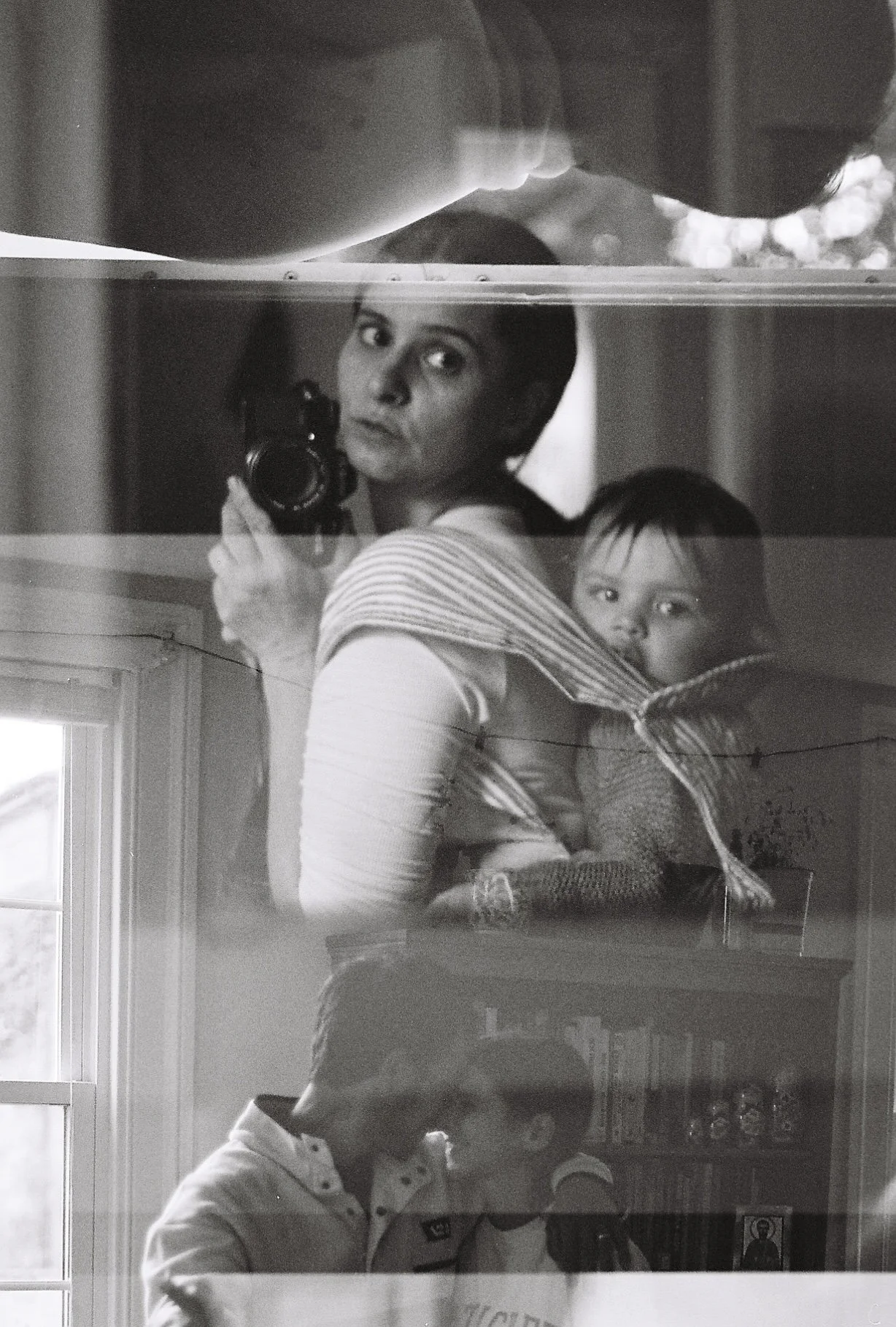 Young mother and son babywearing in carrier black and white analog photography