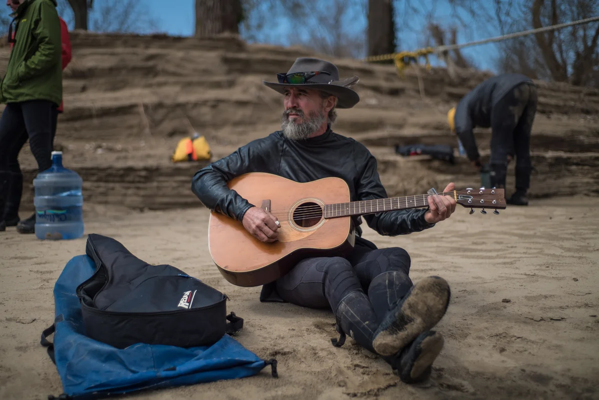 Bluesman John Ruskey noodles the River Guitar after lunch.