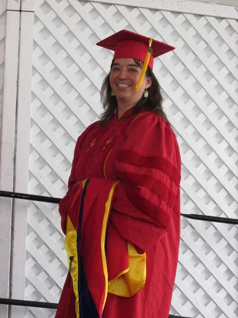 Michelle Damian, now a professor at Monmouth College, walks to accept her diploma.