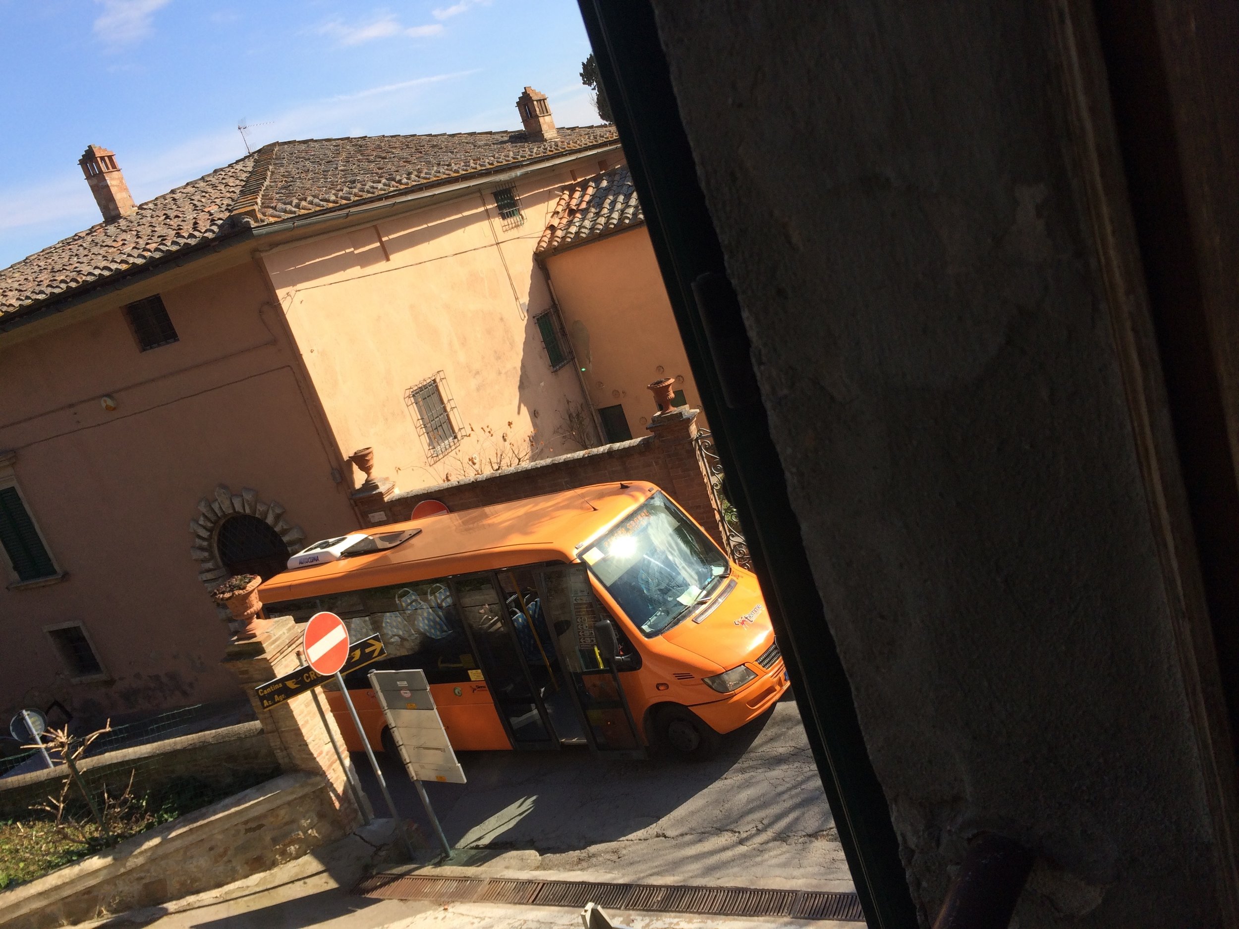 View from the bedroom window. Why is the bus stopped there? Usually it labors up the hill, then on the flat road in front of the apartment, the driver guns it and if you are at the next bus stop, you have to start flagging down the driver, because since they have a full head of steam they want to use that running start up the next hill to the Grande Piazza. 