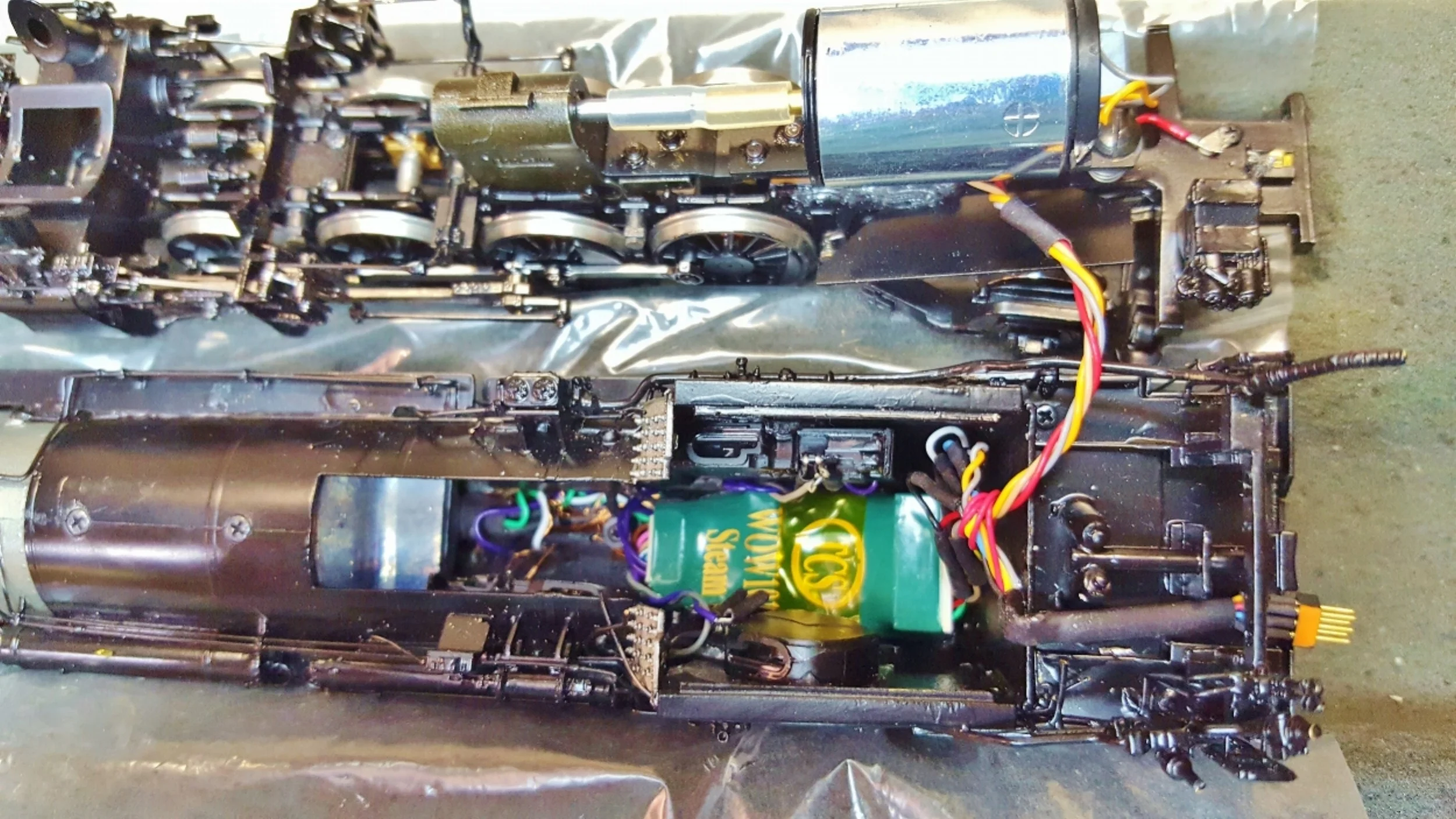 This is a Division Point NYC H10. We are using a WOW decoder. There are 4 specially modified Iphone 4S speakers in the boiler as well as Headlight, Class markers and Cab Light . A custom cam pick up is located under the motor. A Keep Alive is located in the tender.