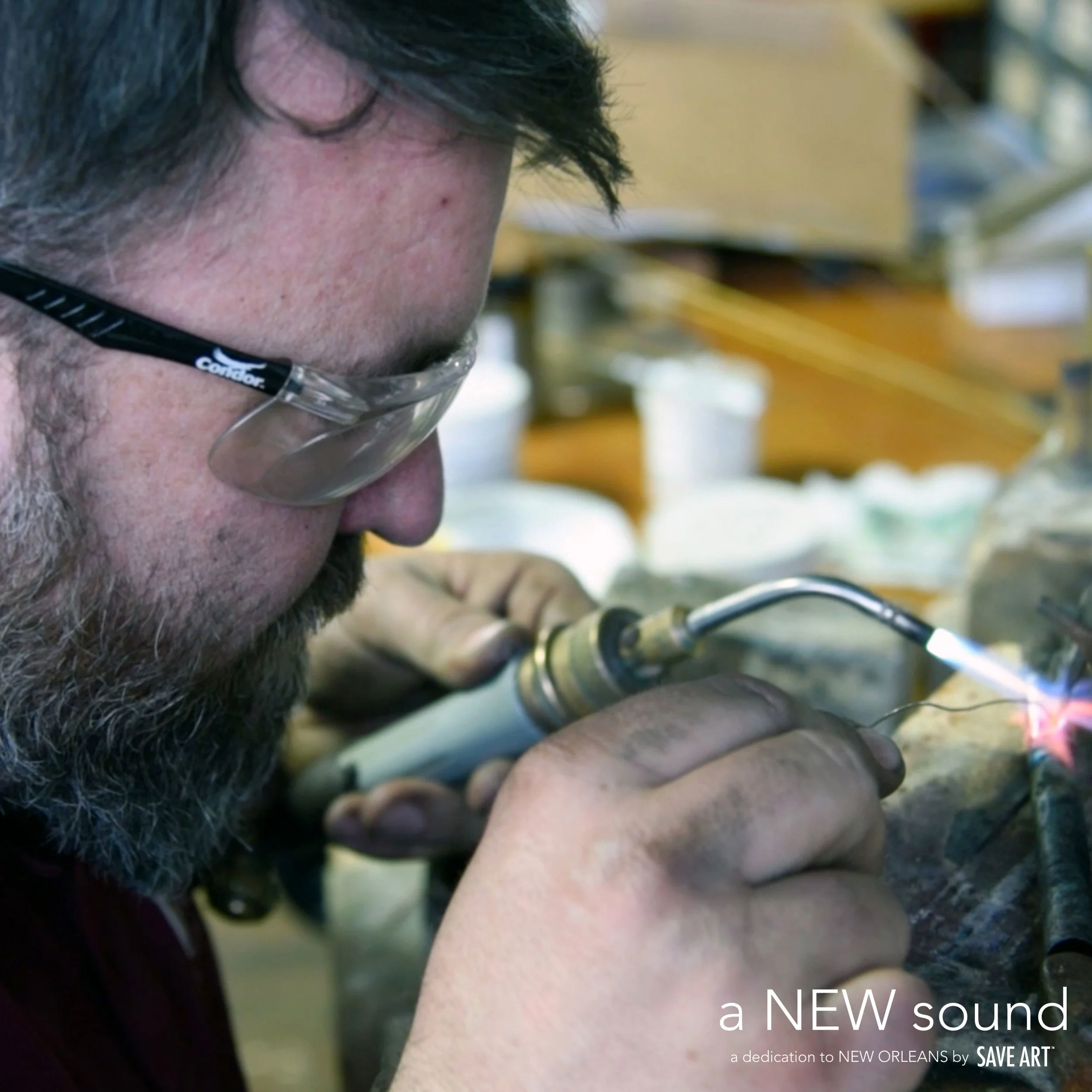 Above: Mike Corrigan welding chicken ornament onto trumpet.
