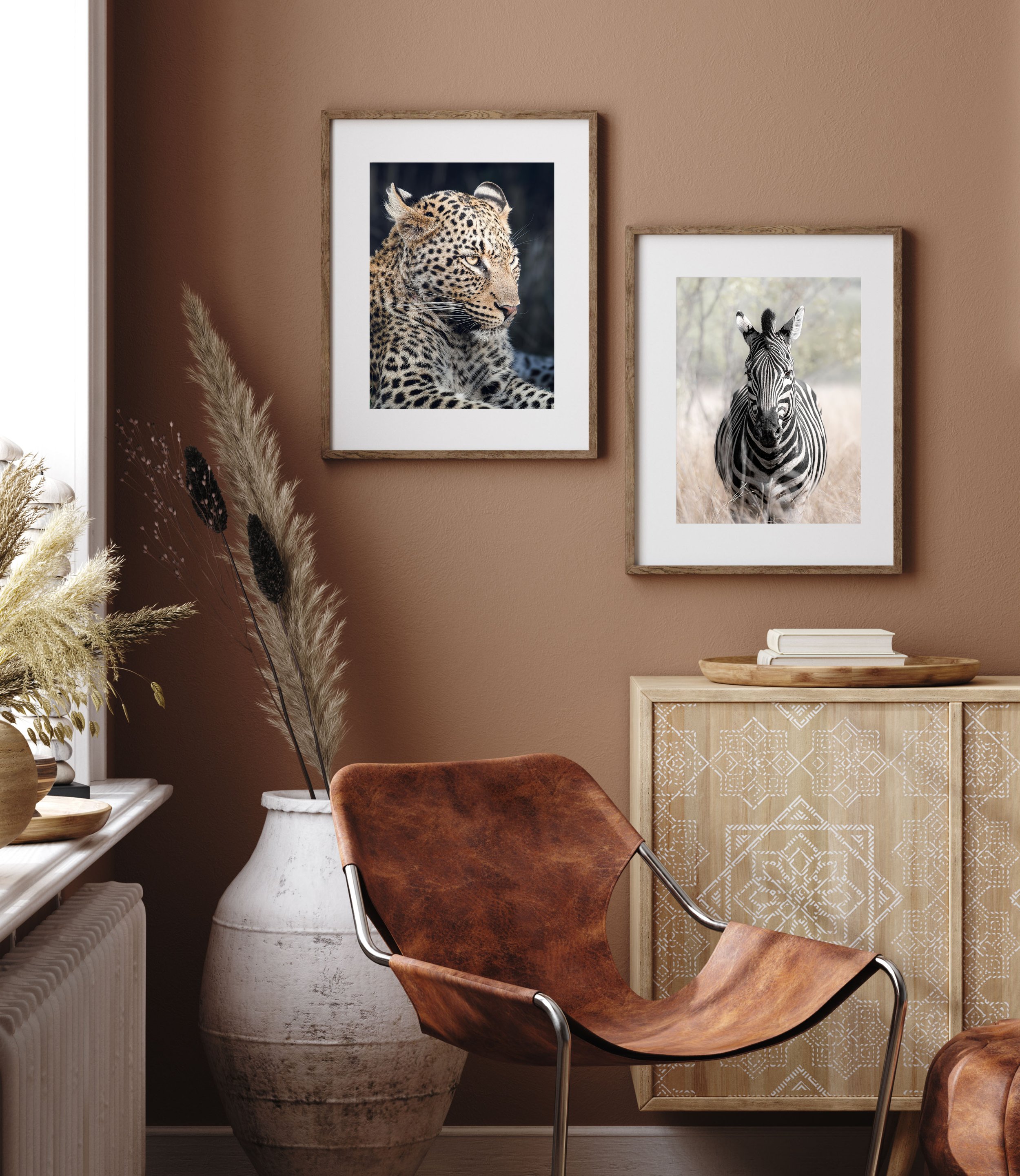 Zebra and leopard print in warm-toned room - Small prints showcasing wildlife in a stylishly decorated room with warm tones.