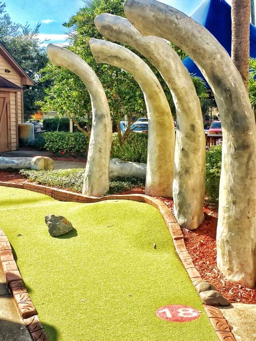 Who's ready to take a shot? hitting the 18th hole in the mini Golf course is dinosaur play.