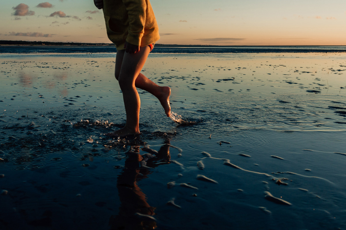 boy at skaket low tide by laura barr photography