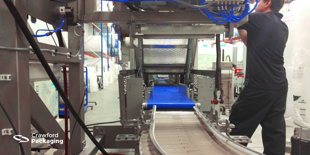 Crawford Packaging's Technician Tim working on a Packaging Automation top sealing machine.
