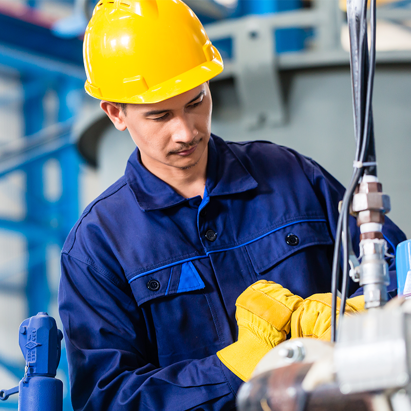 service technician wearing protective clothing fixing packaging machine
