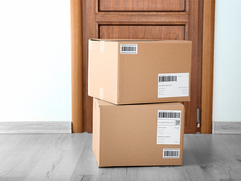 stack of two large shipping boxes on doorstep