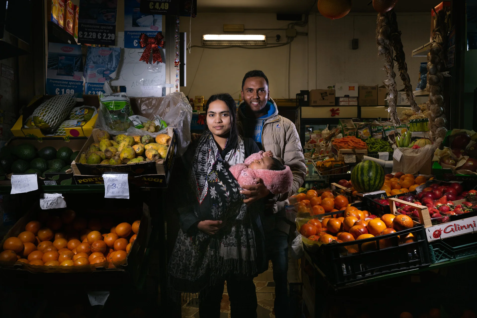 A Environmental Portrait shot in Rome to Al Amin and his family in their fruit shop at Pigneto. Ambient light mixed with 2 led lights. Aperture f5.6 @400 iso