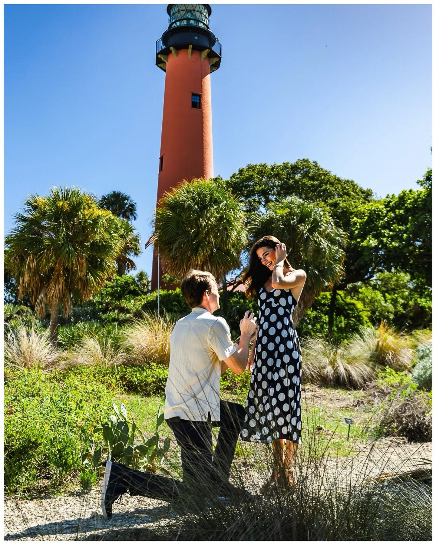 On the edge of the ocean, with the lighthouse standing tall, their forever began. 🌊💡💍