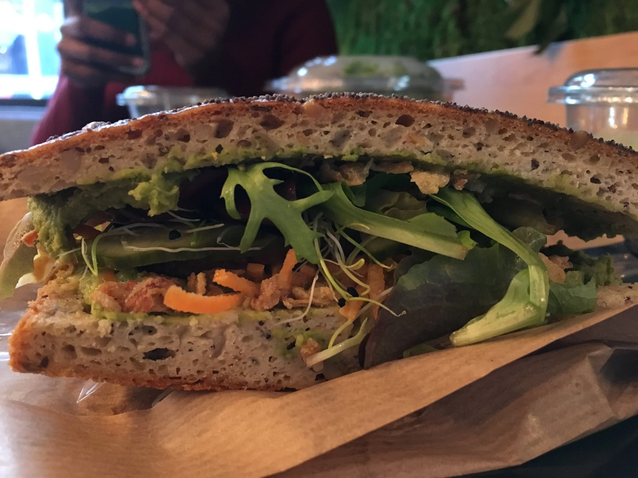 Vegan sandwich with hummus, avocado, and roasted tofu!