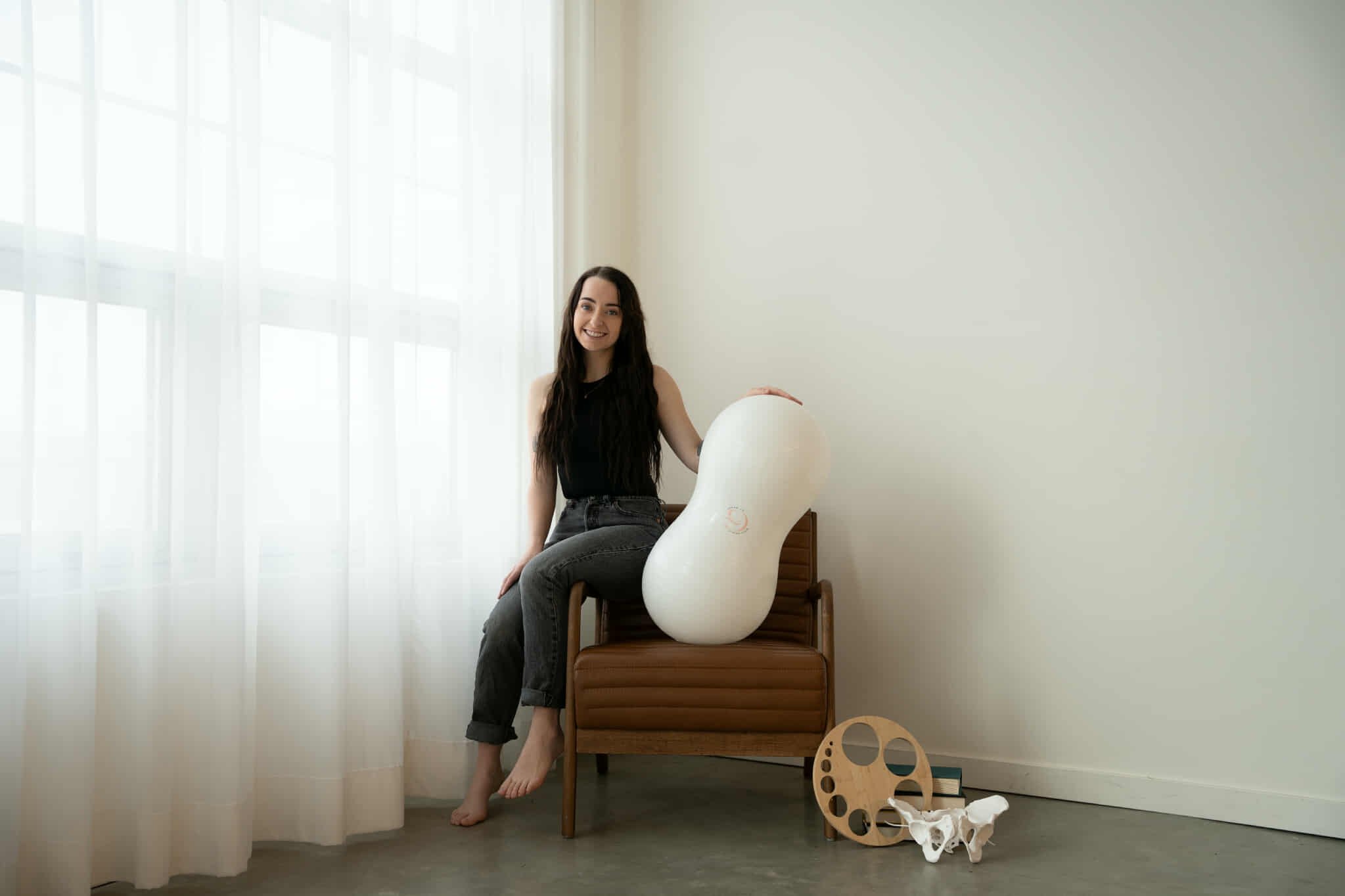 Smiling person with long, wavy hair indoors.