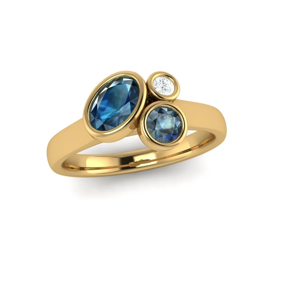 our signature cluster design bezel set with teal blue sapphires and Diamond in Yellow Gold