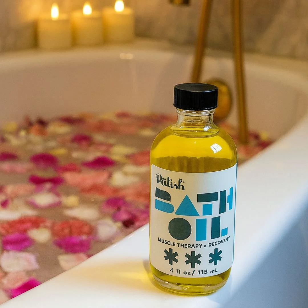 Beautiful bathtub filled with flower petals and next to it is the bath soak made with peppermint for an uplifting experience by palish.jpg
