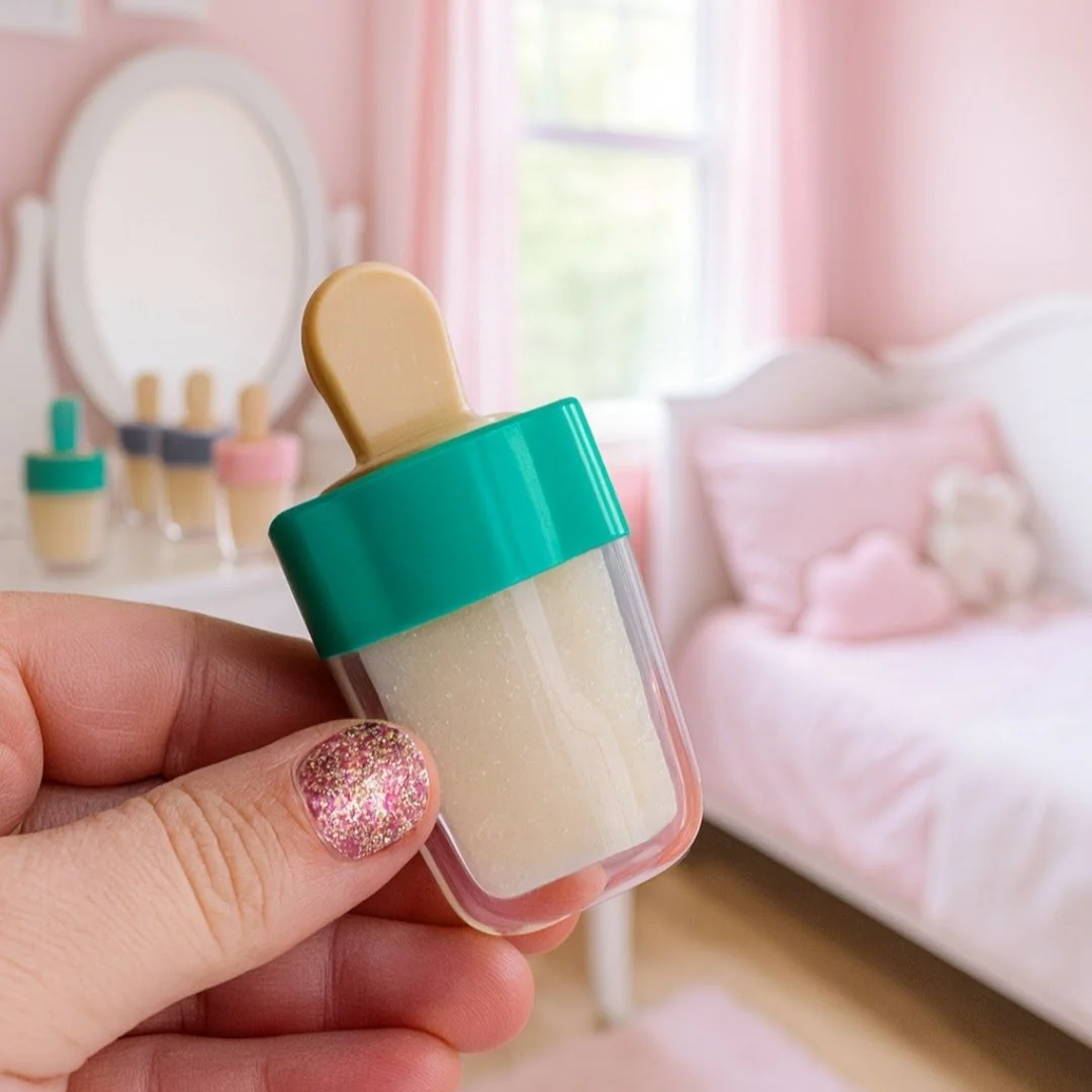 Girl holding cute natural popsicle shaped lip gloss in a pink bedroom perfect for clean beauty lovers of lips gloss made in ohio.jpg