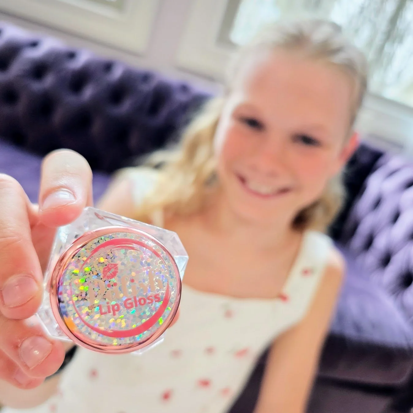 Girl holding the palish sparkle all natural lip gloss jar created in small batches in columbus ohio for hydrated and shiny lips.jpg (Copy)