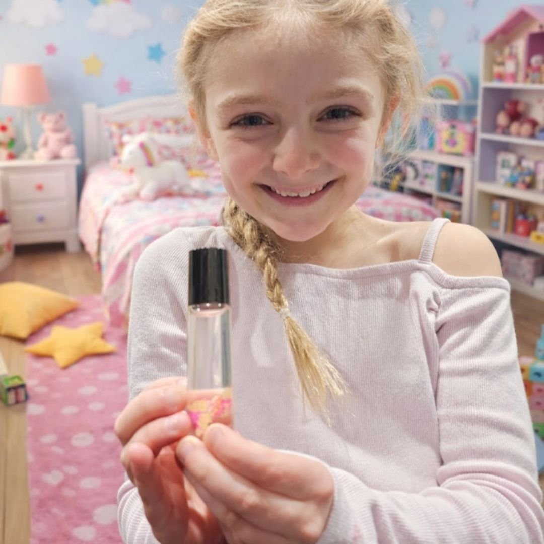 Girl holding the natural palish lip oil in a cute room for all ages made in ohio .jpg