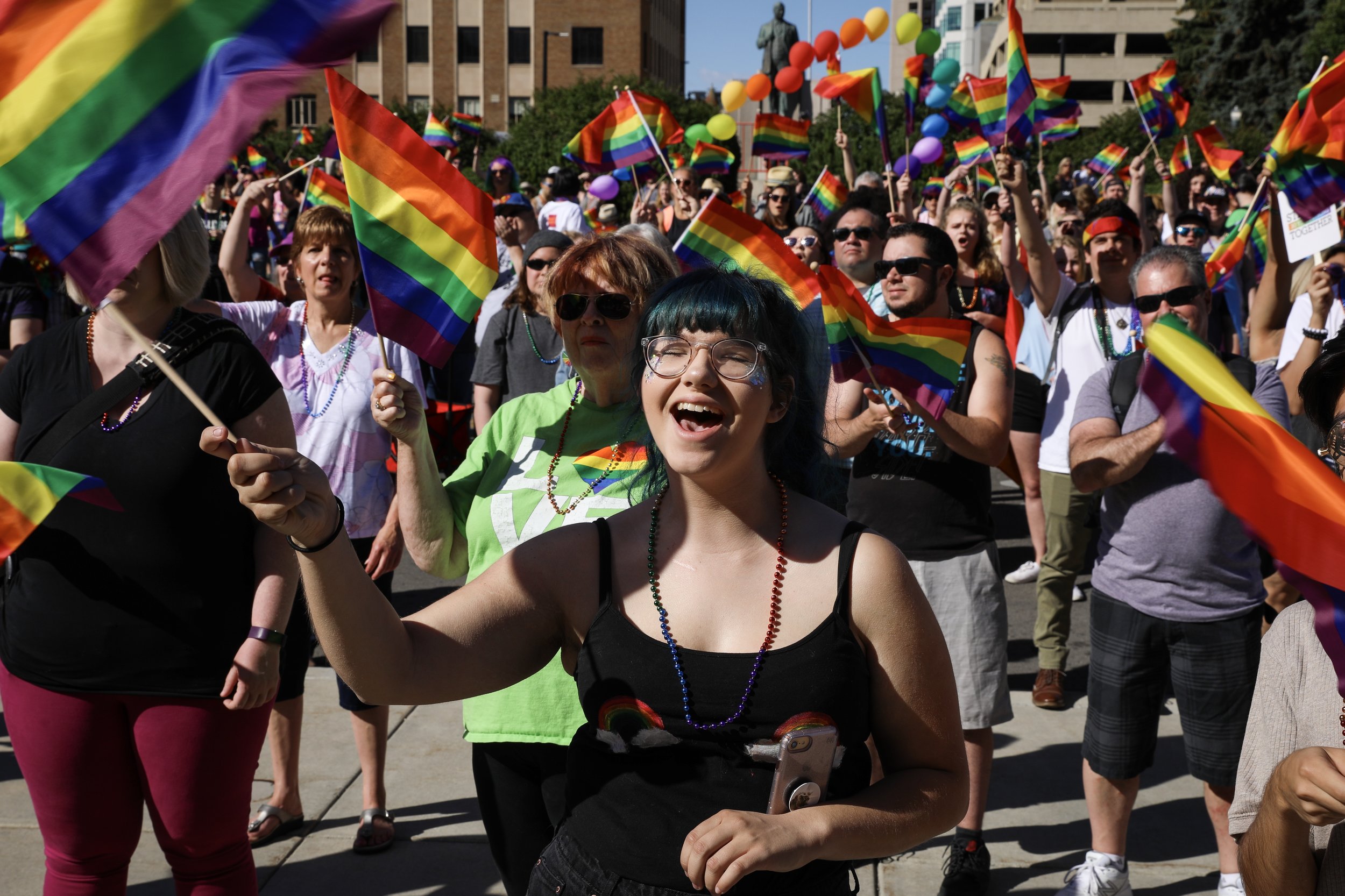 Emily Talbot, center, waves a rainbow flag to support a speaker during a rally at 2018 Boise Pride Festival in downtown Boise on Saturday, June 16, 2018. Talbot identifies herself as bisexual. 