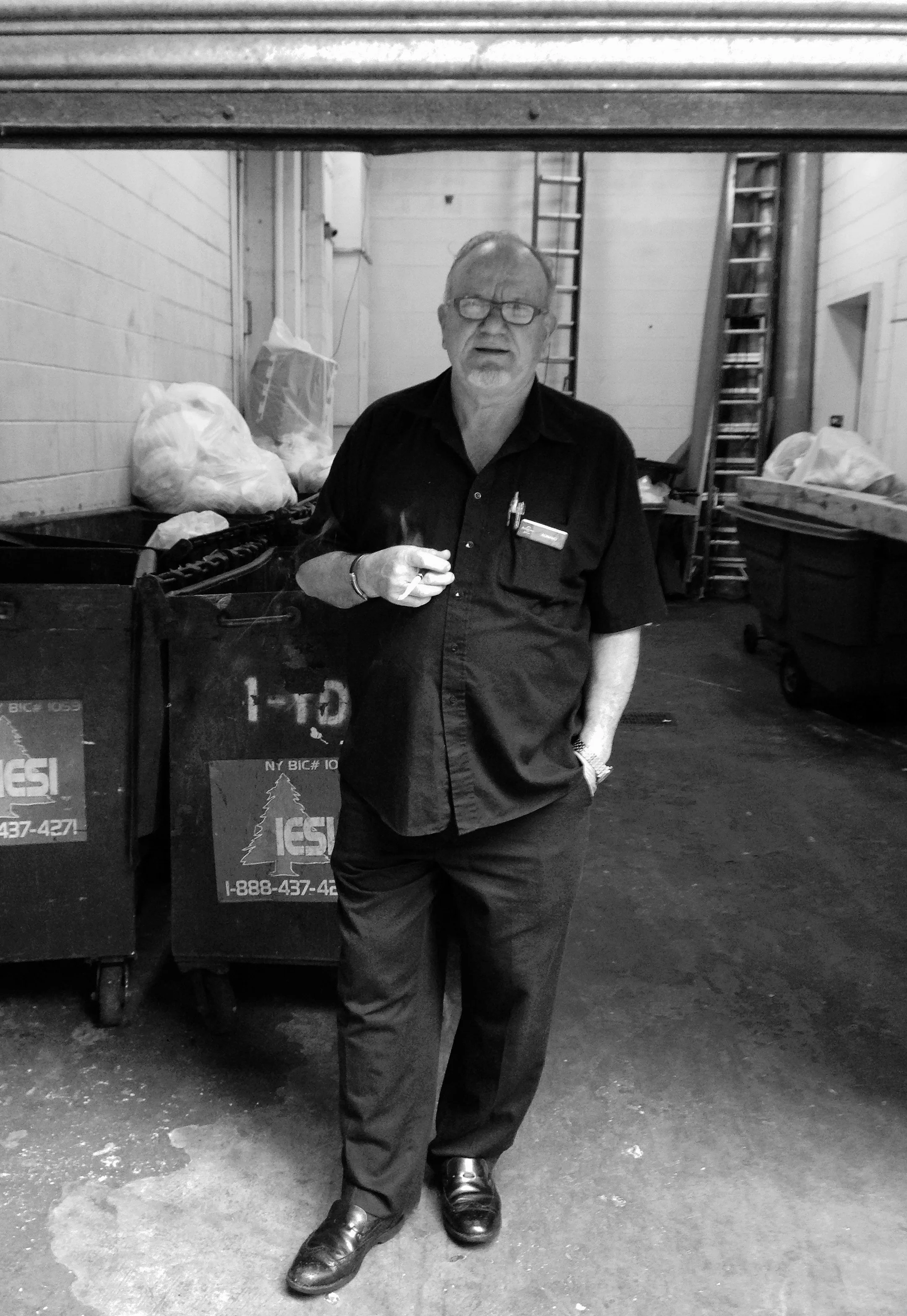 IMG_5768 Man Smoking In Service Entrance B&W.jpg