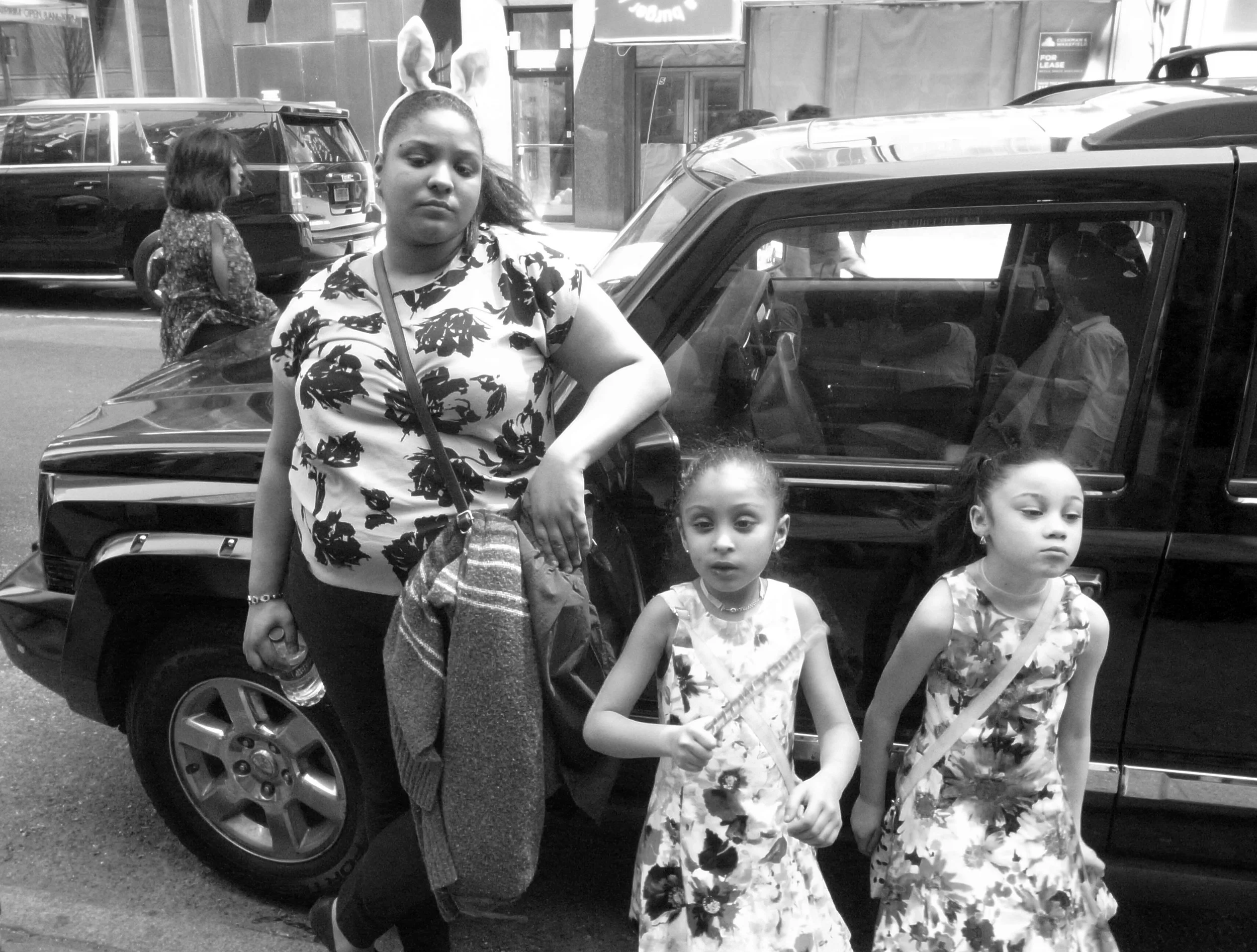 R0011376 Easter Parade Woman With Girls Lenaing On Car.jpg