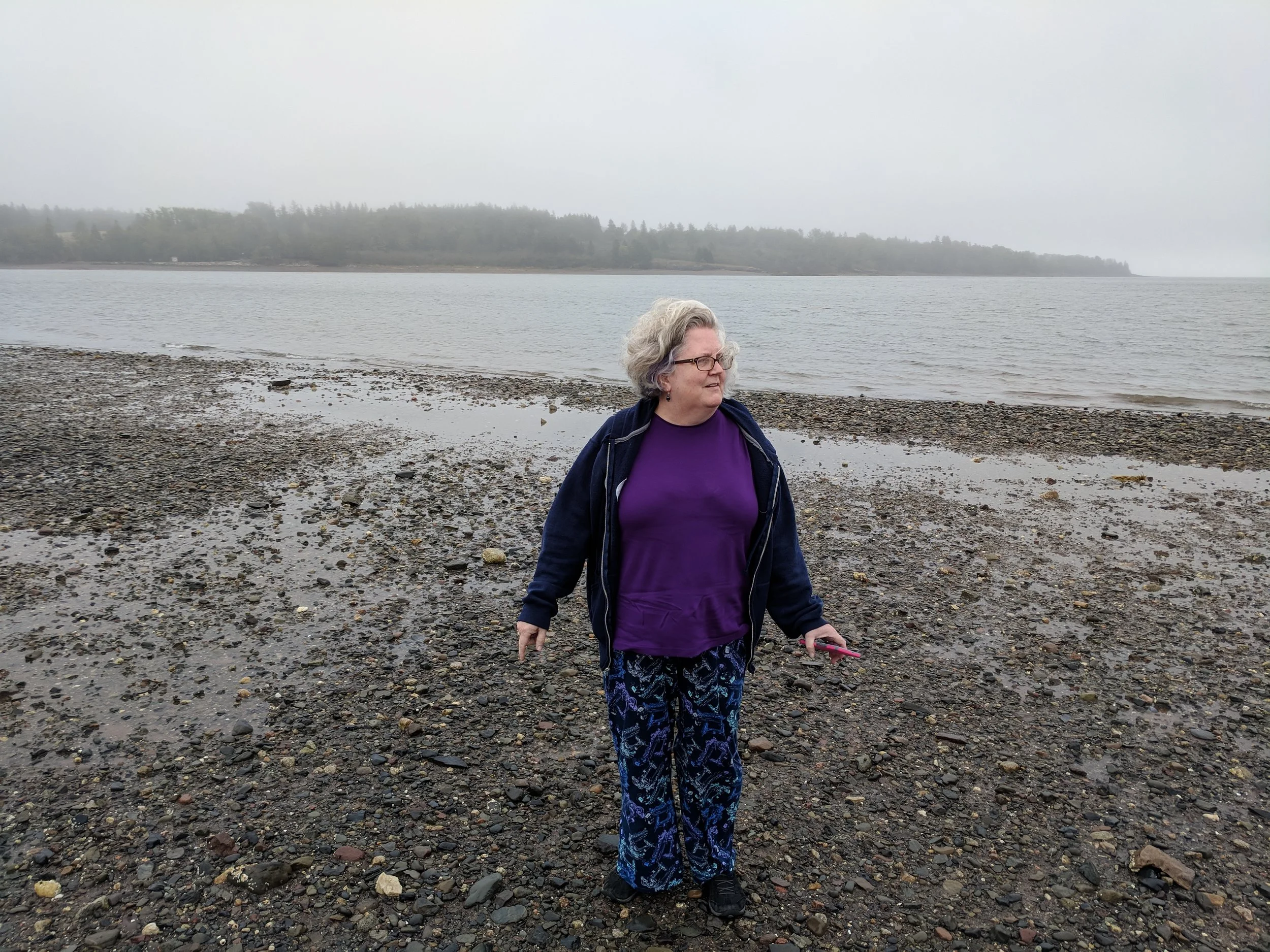 Mindy is standing on the ocean floor. She would be underwater (and then some) at high tide.