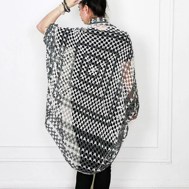 Woman wearing a black and white knitted shawl