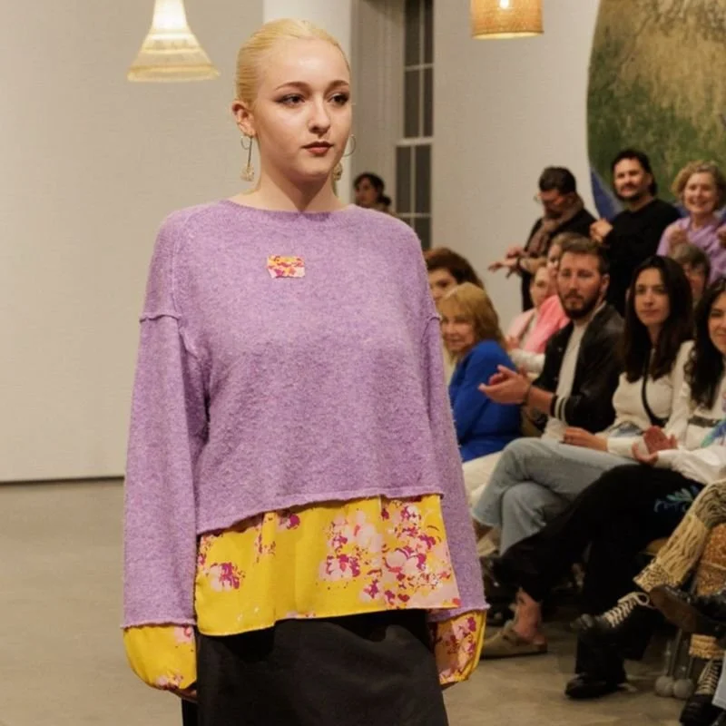 Model wearing Crooked Stitch upcycled purple and yellow top