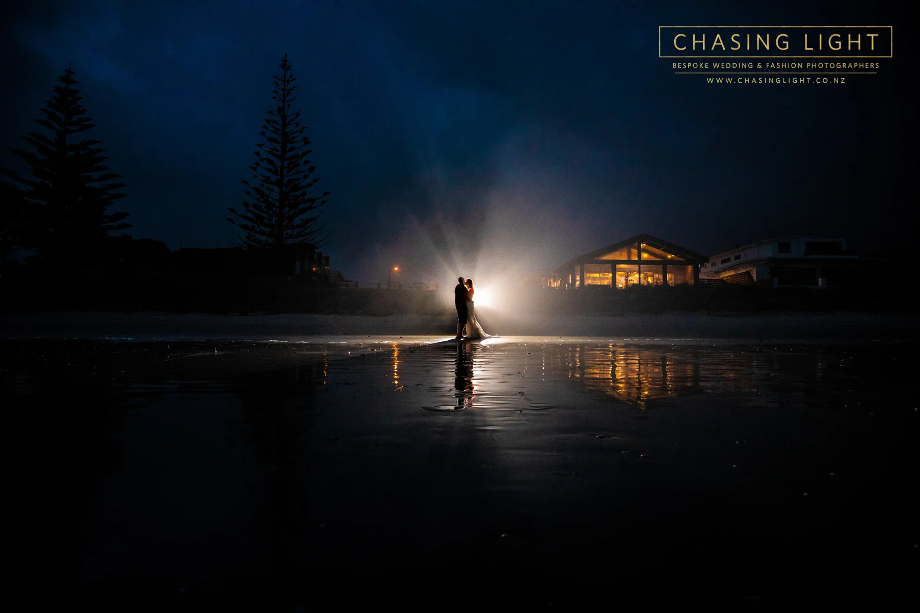 Nikki + Stuart outside Flat White Wedding Venue, Waihi Beach. © Chasing Light 2019.