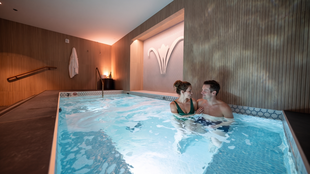 Couples relaxing in the Vitality Pool at Sole'renity Spa