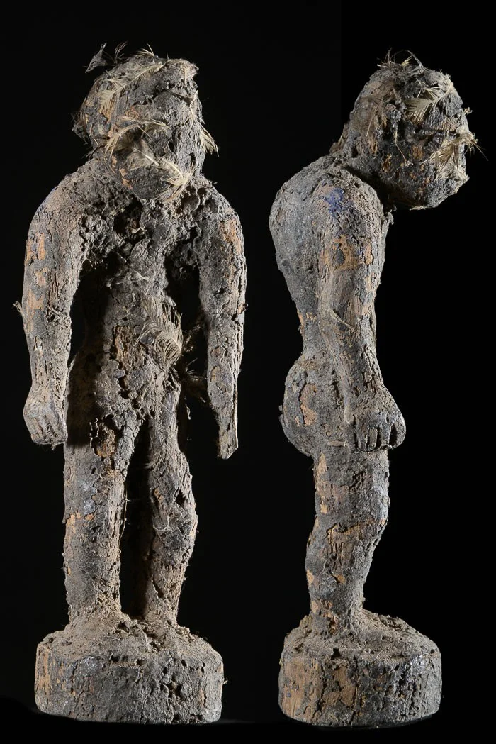 A voodoo fetish doll (bocio) . The bocio is kept in the home in a shelter covered in palm leaves. It is "fed" by pouring animal blood and palm wine on it. It serves as a sentinel watching over a house, clan, village, secret society or individual. Height: 10 in (25 cm). Fon tribe, Benin.