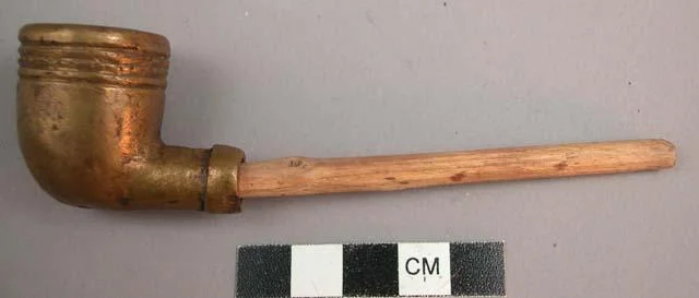 A brass imitation of an American pipe. Gio, Liberia.
