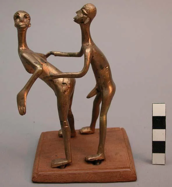 Brass figure of two people copulating. Benin. Height: 13 cm (5.1 inches).
