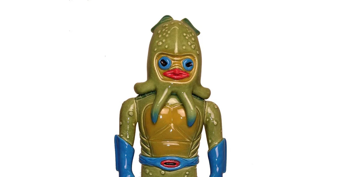 Takoshi (Octopus Death) is the villain in the Yakimon world. An evil deformed genius who wears an organically engineered octopus helmut. He is a master of genetic engineering. His masterpiece being a species of Ikakumora, spider/squid hybrids to do his bidding.
