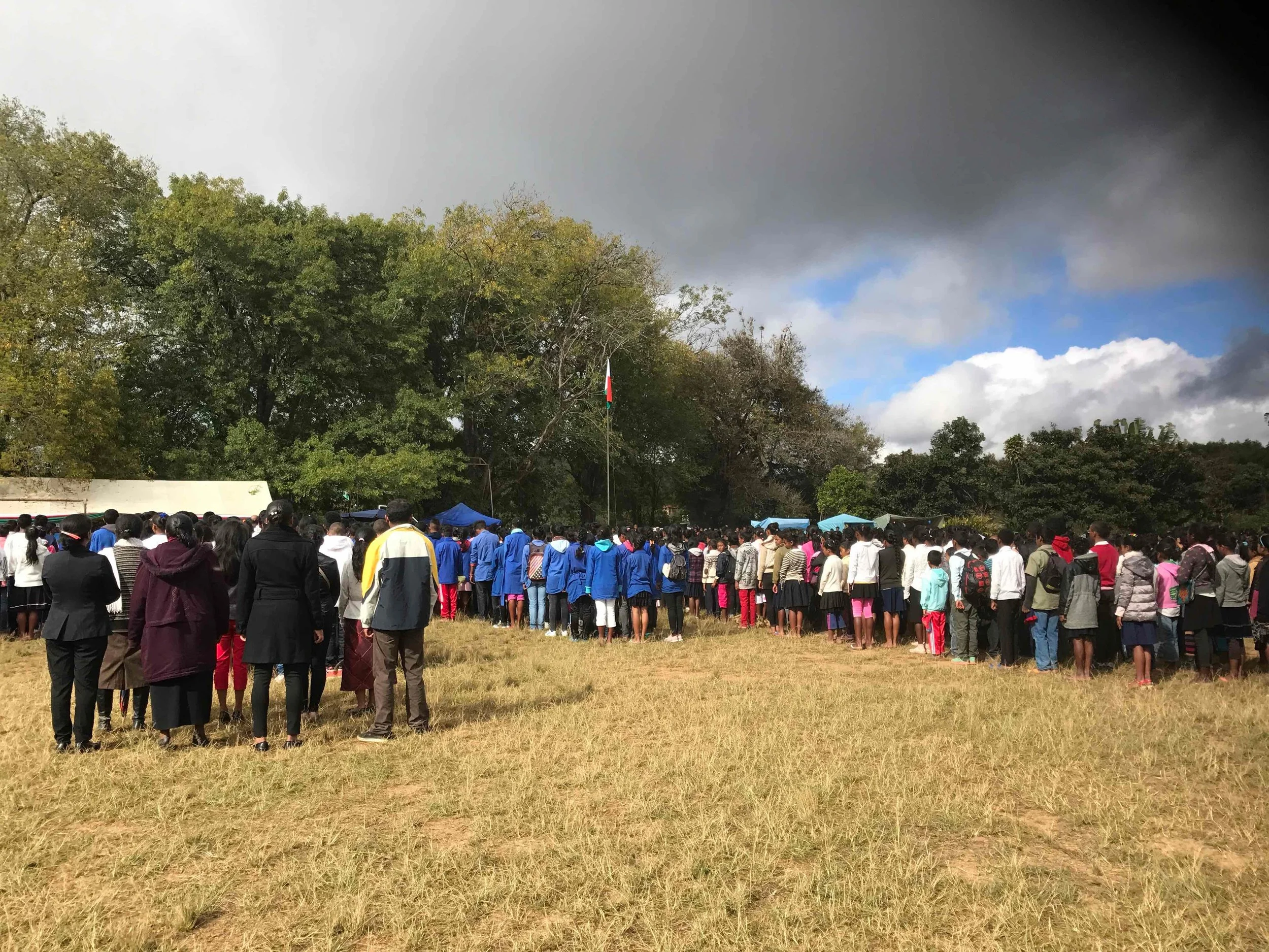 People of Mantasua raising the Malagasy flag in celebration of 57 years of independence. 
