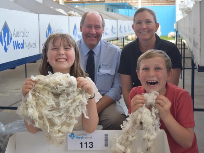 Happy days: Kirstie Anderson, from Avington Merino stud, with agent Ron Creek, Australian Wool Network, and children Georgie, 8, and Jack 10, at Melbourne, where the family offered superfine wool for sale. Picture: Jamie-Lee Oldfield