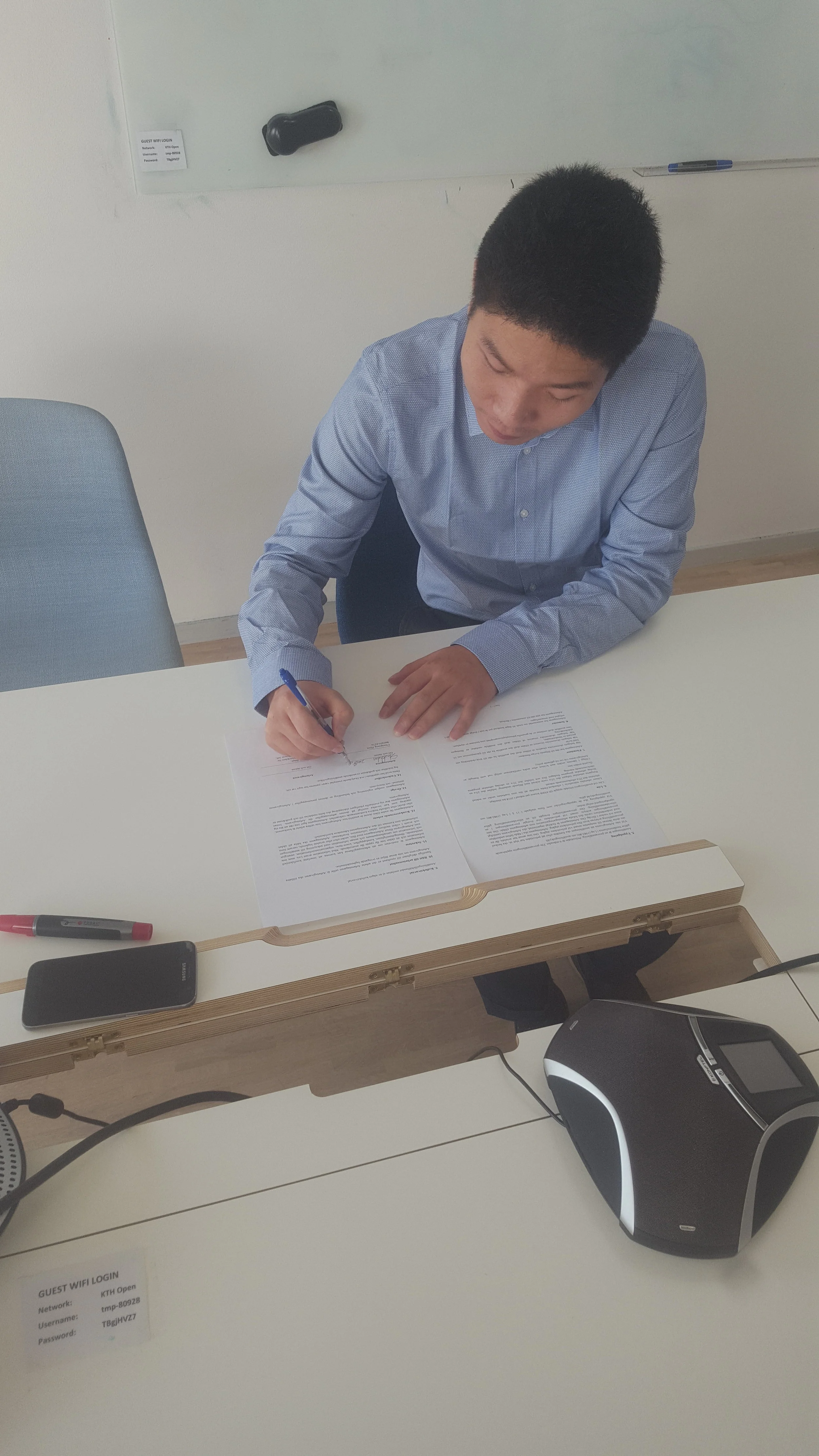 Chun signing his employment contract!