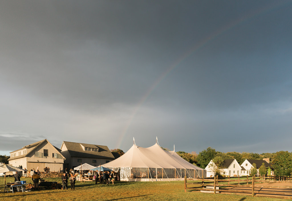 Outdoor tented wedding on a farm! This is inspiration for future brides looking to plan a beautiful outdoor wedding. Check out the beautiful rainbow too! Planner: Pearl Weddings & Events