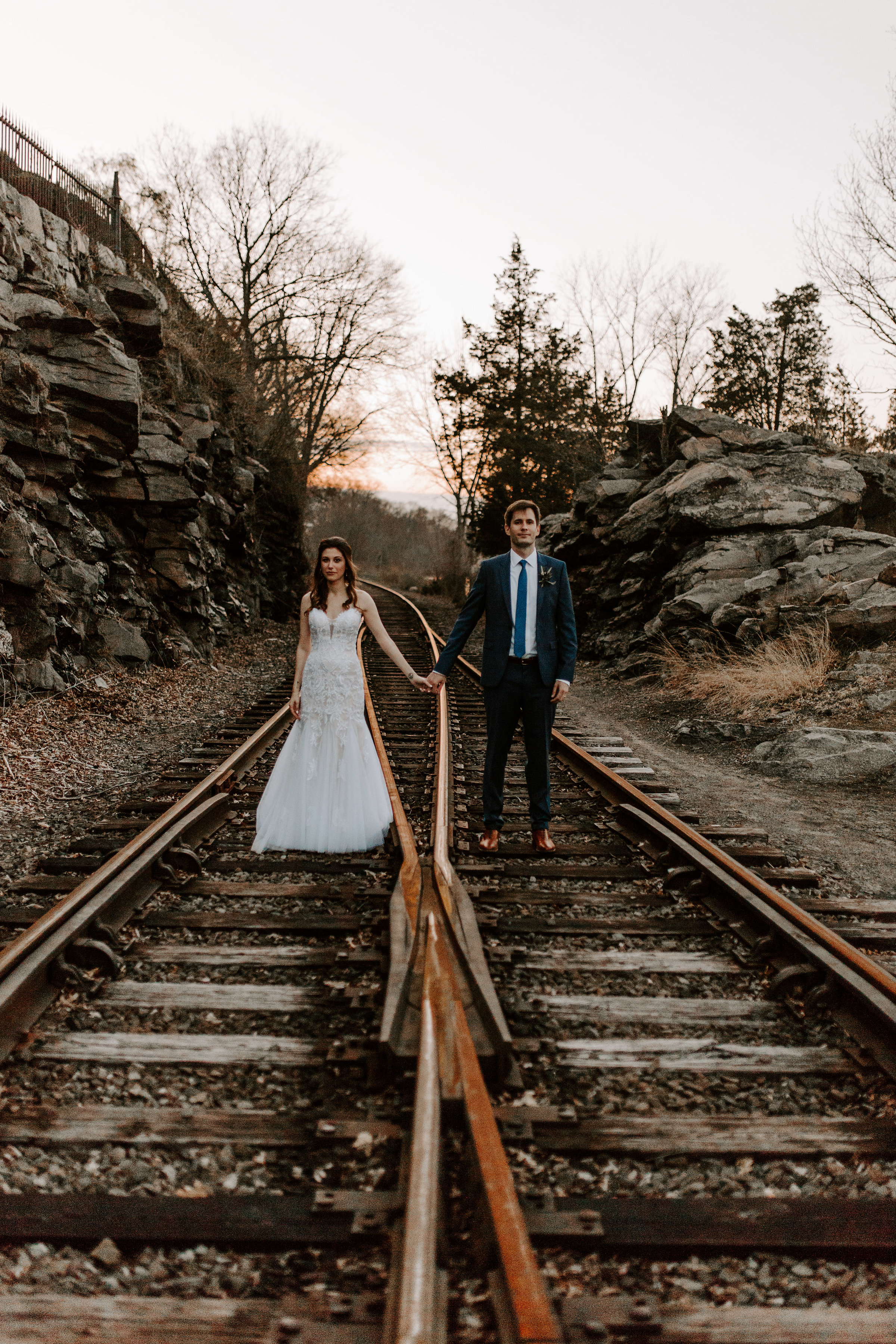bride and groom on the train tracks looking fly. - Pearl Weddings & Events