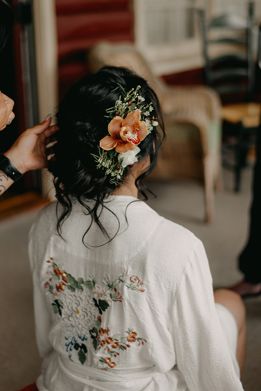 Bride with flowers in her hair and a wedding robe! - Pearl Weddings & Events