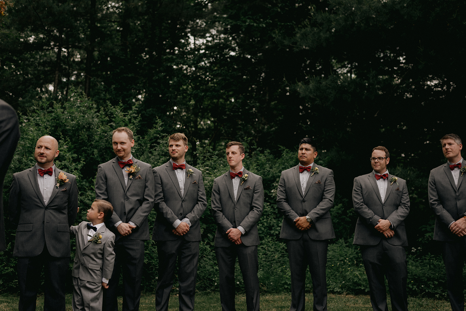 Groomsmen dress in grey suits with red bowties - Pearl Weddings & Events