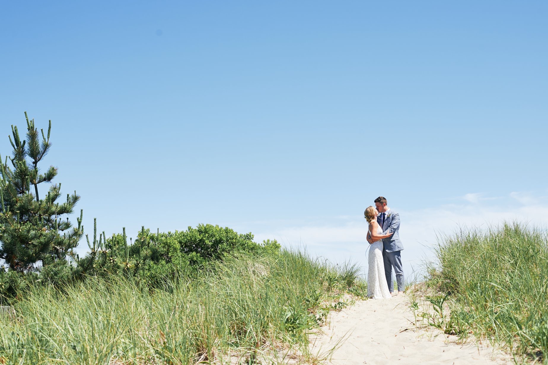 First look on the beach with the bride and groom in Rhode Island - Pearl Weddings & Events