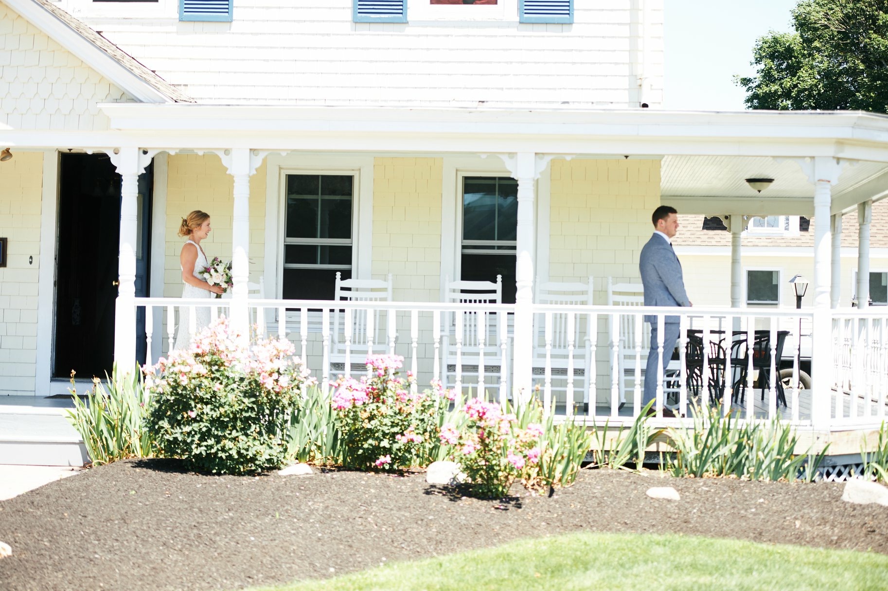 First look on the porch at the Admiral Dewey Inn in Rhode Island - Pearl Weddings & Events