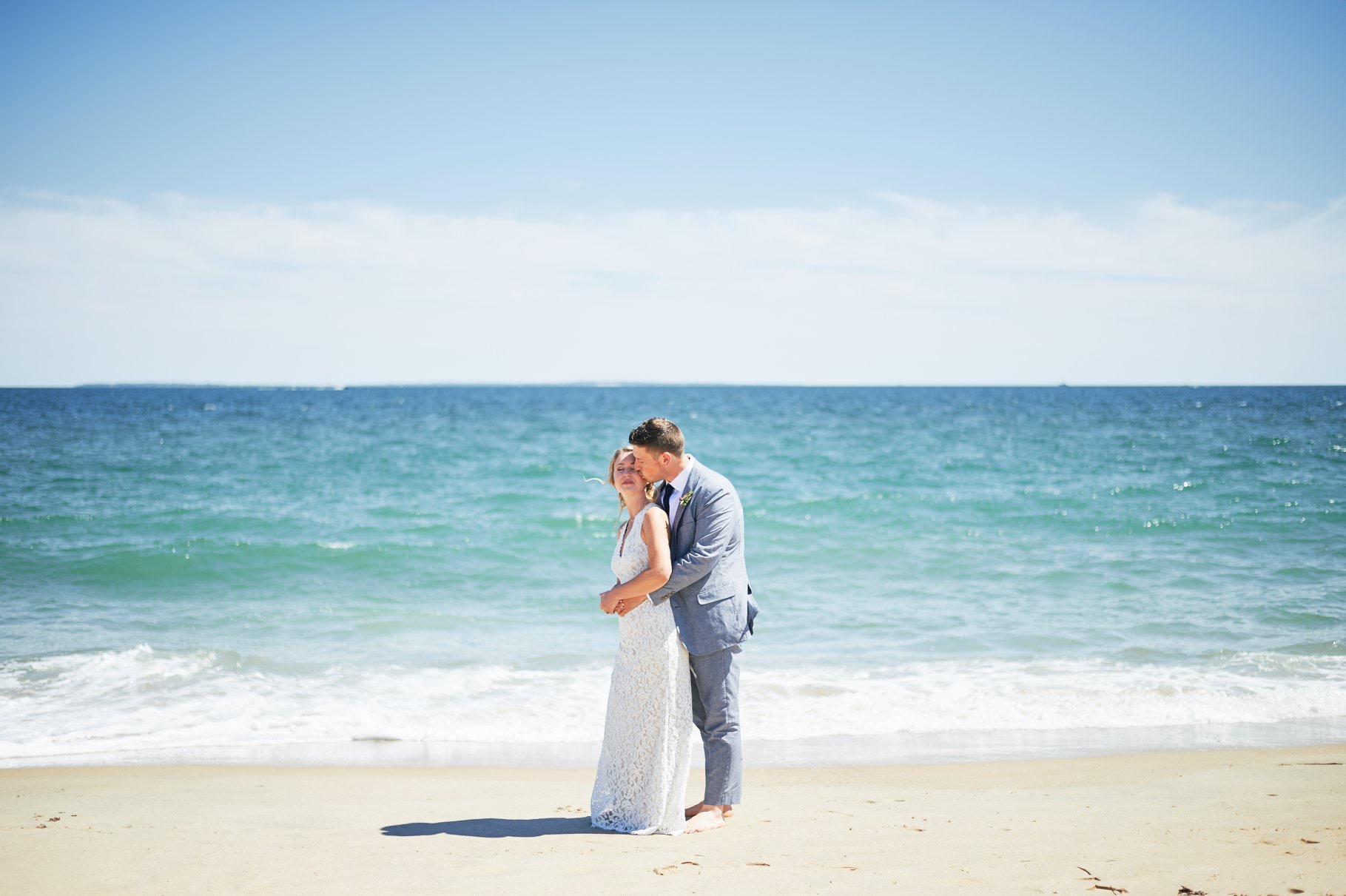 Bride and groom by the ocean on their wedding day - Pearl Weddings & Events