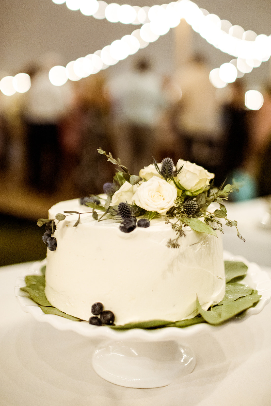 Simple white cake with greenery and blueberries - Pearl Weddings & Events